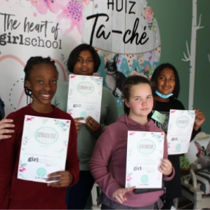 Young teen girls boasting with their Girl-School certificates.