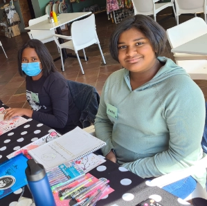 Young girls smiling while attending Girl-School class.