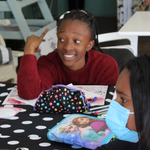 Young black girl listening with intent in Girl-School class.