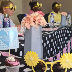 Young girls wearing funky glasses in Girl-School class.